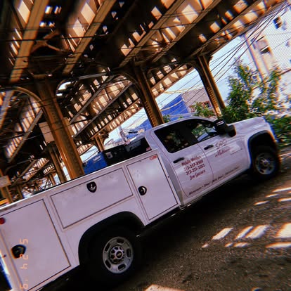 J&J Multiservices mobile welding truck parked under elevated train tracks in Chicago